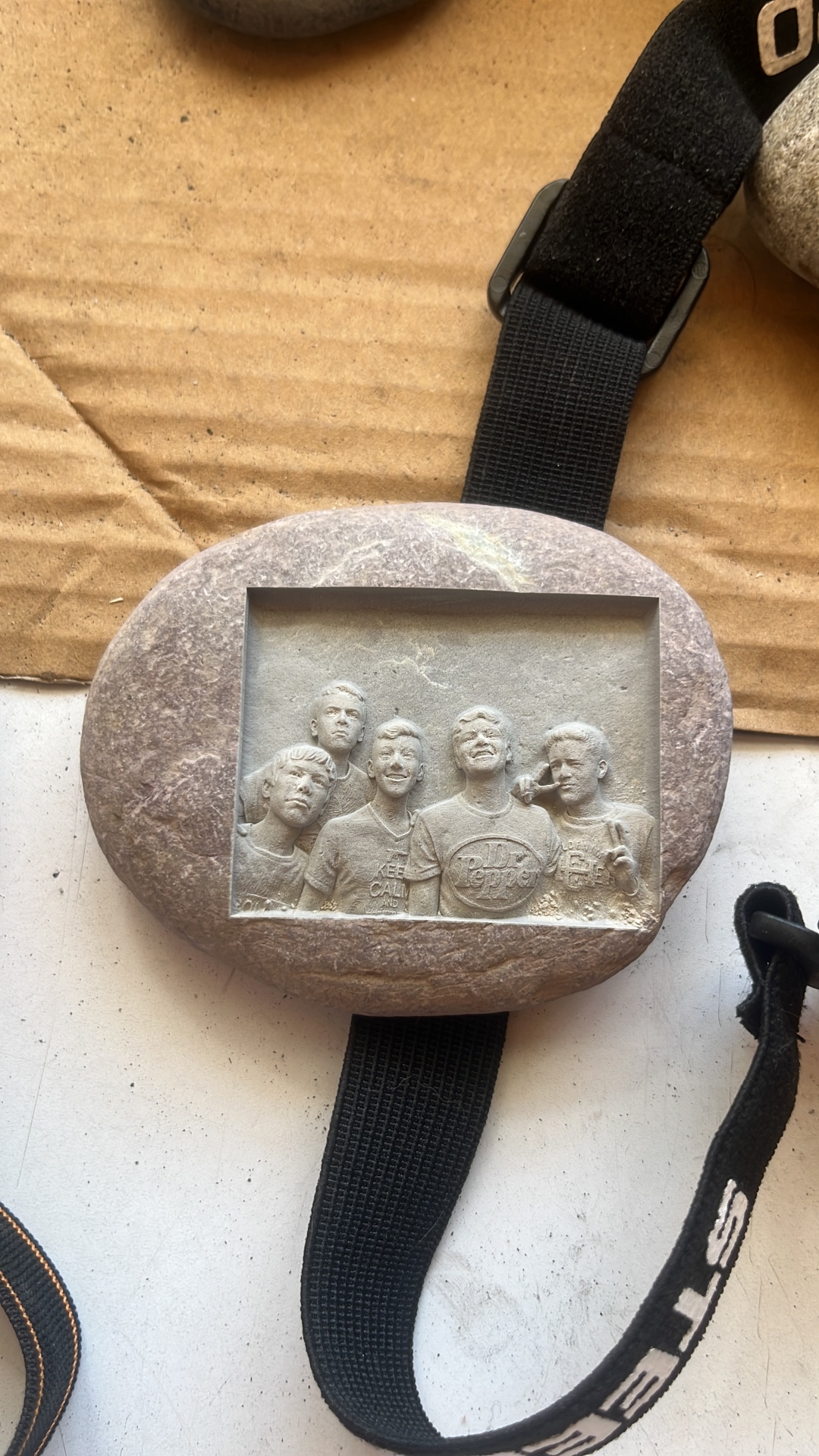 Family portrait engraved on an oval grey natural stone